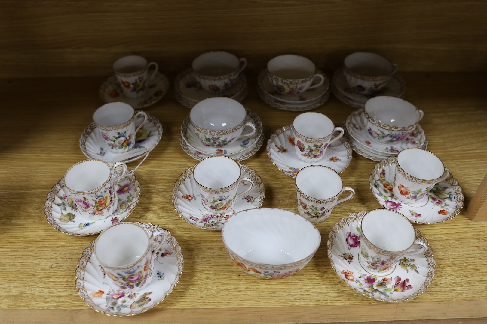 A quantity of Nymphenburg and Dresden porcelain cups and saucers